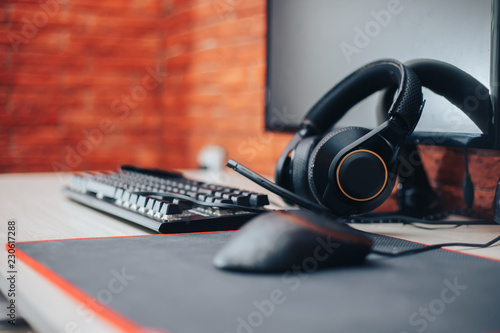 Gaming arena background with mouse gear headphones computer, focuse on headphones selected focuse