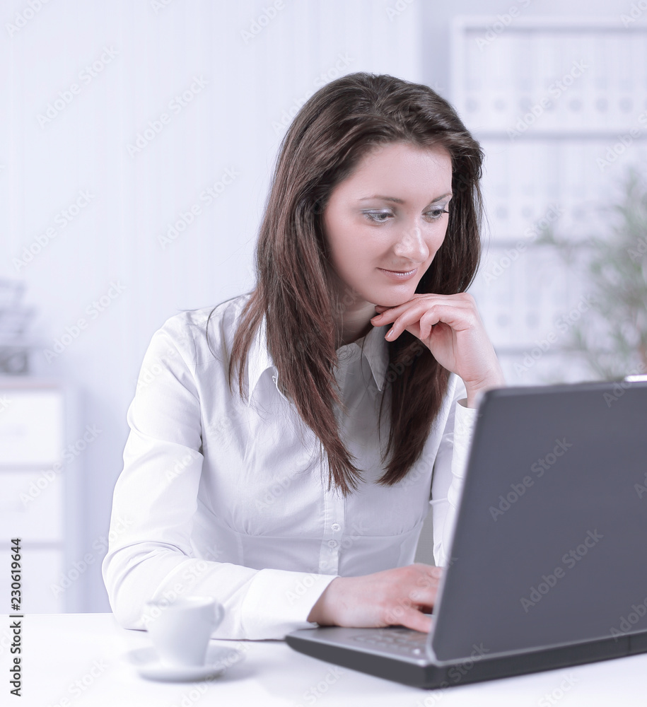 friendly female employee sitting at her Desk. friendly female employee sitting at her Desk.