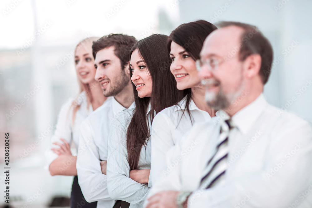 concept of team work - the leader and the business team standing one behind the other concept of team work - the leader and the business team standing one behind the other