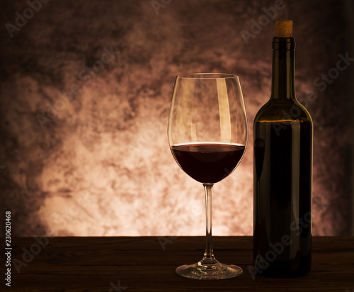 Glass with Red Wine on wooden background