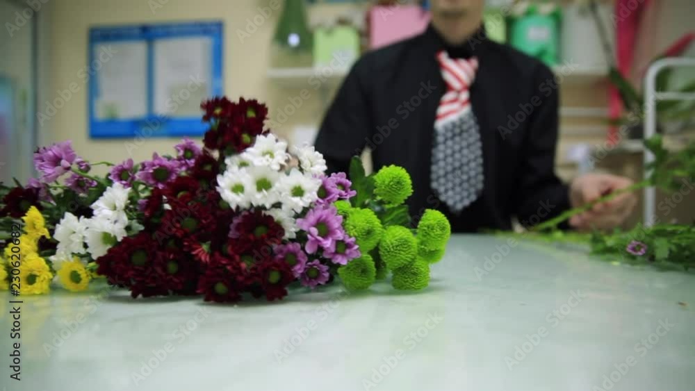 HD Florist prepares flowers for a bouquet. Close up shot HD Florist prepares flowers for a bouquet. Close up shot