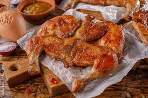 Gentle baked chicken on a wooden background. photo