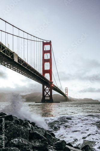 Golden Gate Bridge view from coast line, ocean waves