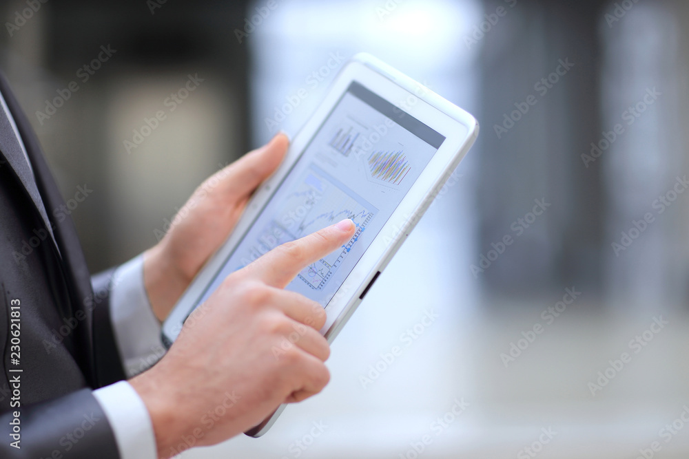 close up.businessman working on a digital tablet with financial