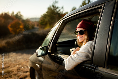 Woman driving in the car on the road trip