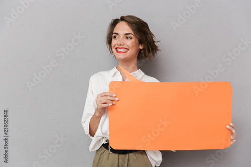 Portrait of a joyful young woman standing