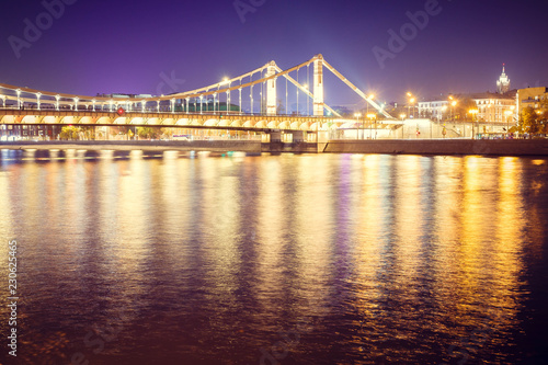 The long beautiful bridge across the river in the evening. © PhotoBank