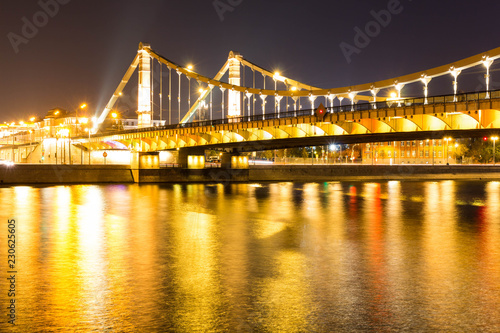 The long beautiful bridge across the river in the evening.