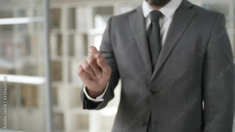 Mid-section shot of businessman in suit making spreading gesture on invisible AR interface. Footage suitable for adding augmented reality or holographic screen Mid-section shot of businessman in suit making spreading gesture on invisible AR interface. Footage suitable for adding augmented reality or holographic screen
