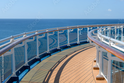 View from the deck of the cruise ship to the ocean. Sea horizon, clouds, blue tropical sky