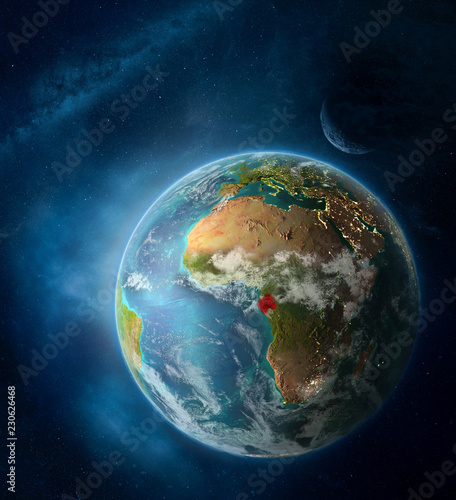 Fototapeta Naklejka Na Ścianę i Meble -  Gabon from space on Earth surrounded by space with Moon and Milky Way. Detailed planet surface with city lights and clouds.