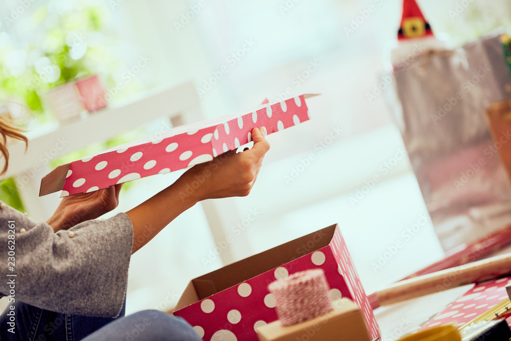 Woman preparing presents for family and friends for Christmas and New Year. Holiday concept. Woman preparing presents for family and friends for Christmas and New Year. Holiday concept.