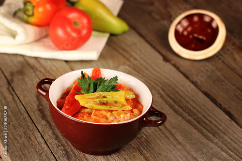 Hungarian Lecso - pepper and tomato stew on wooden background