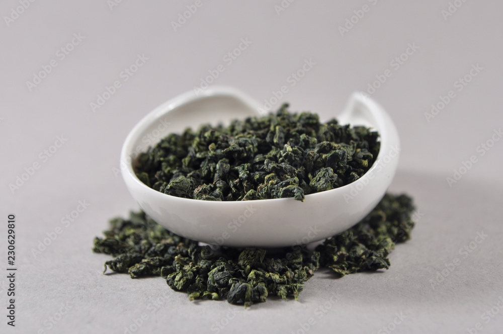 Chinese green tea in tea ware. Infusions. Heap of dry tea leaf. Chinese green tea in tea ware. Infusions. Heap of dry tea leaf.