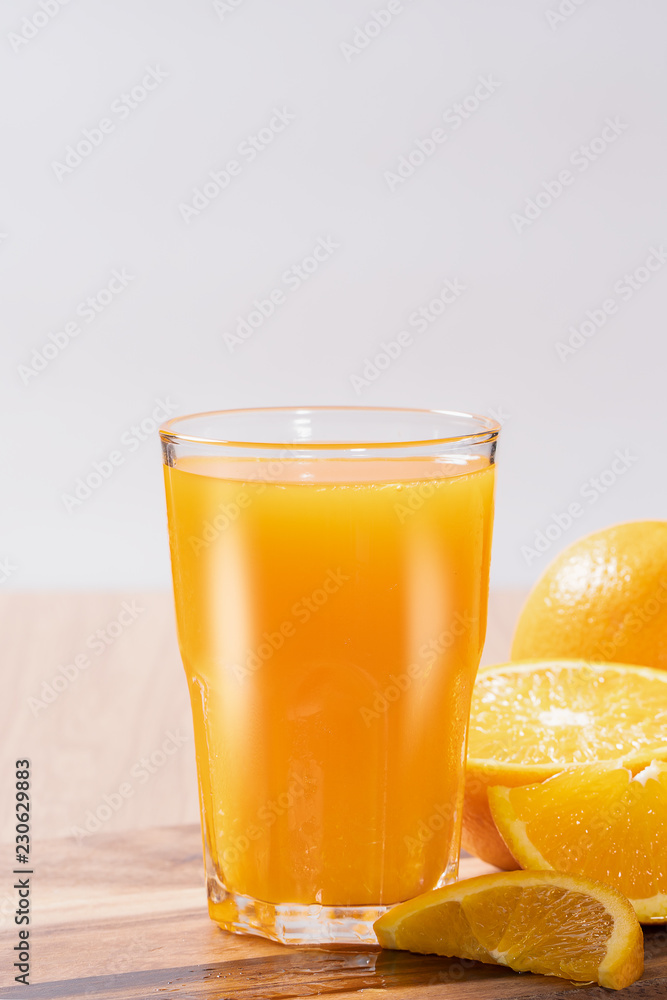 Glass of orange juice with fresh fruits on wooden floor Glass of orange juice with fresh fruits on wooden floor