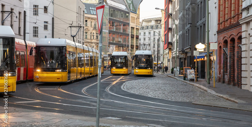 Yellow trams in the city center, office buildings background