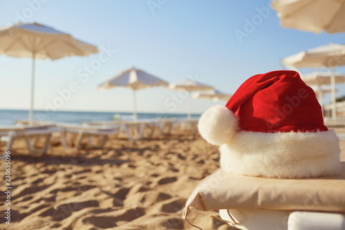 Santa Claus hat on the beach on Christmas Day. The concept of Christmas by the sea.
