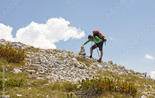 Hiker with a stone man - Vran mountains