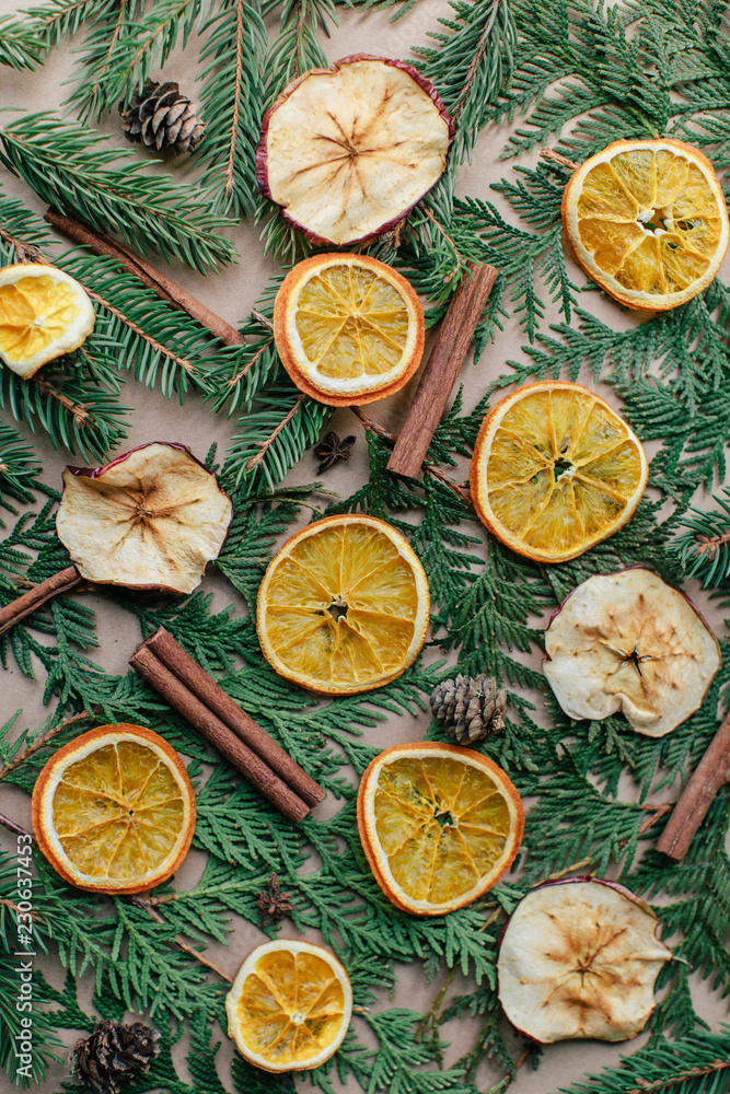 top view of fir branches, cinnamon and dried oranges, christmas pattern top view of fir branches, cinnamon and dried oranges, christmas pattern