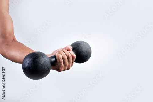 Hand holding dumbbells on white background photo