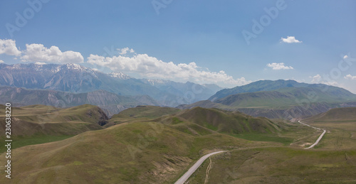 Kaldamo Pass Ak-kya – Kazarman Downhill or Level Roads. Mountains in Kyrgyzstan Near Kazarman. Gravel Curves in Kyrgyzstan photo