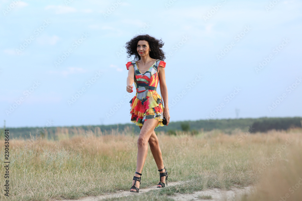 beautiful brunette woman in a field at sunset beautiful brunette woman in a field at sunset
