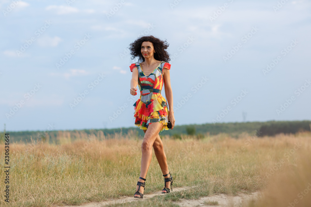 beautiful brunette woman in a field at sunset beautiful brunette woman in a field at sunset