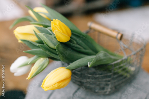 bouquet of yellow tulips on wooden table