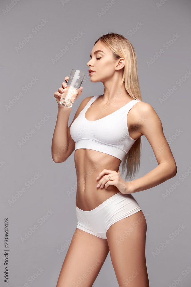 Perfect slim toned young body of the girl or fit woman at studio. The  fitness, diet, sports, plastic surgery and aesthetic cosmetology concept.  Stock Photo