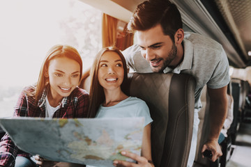Group of Young Smiling People Holding Paper Map