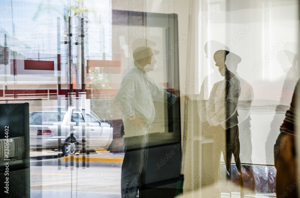 Fototapeta premium siluetas y reflejos en oficina, guardia de seguridad, vidrios y ventanas de hospital con reflejos