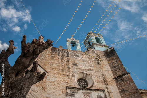iglesia de huaquechula puebla mexico, vista nocturna y atardecer, entre nubes cruz en contraste photo