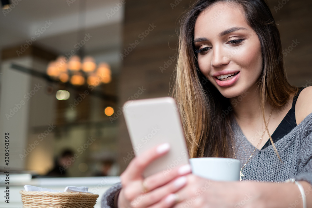 young woman using digital tablet in cafe