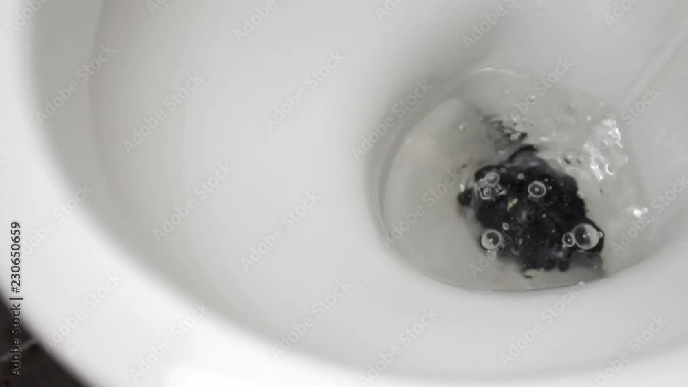 The phone falls into the toilet water. Slow motion. The phone falls into the toilet water. Slow motion.