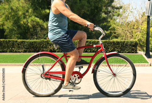 Man riding bike outdoors on sunny day
