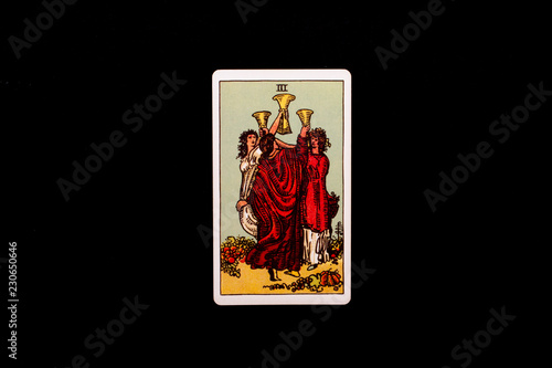 An individual minor arcana tarot card isolated on black background. Three of cups.