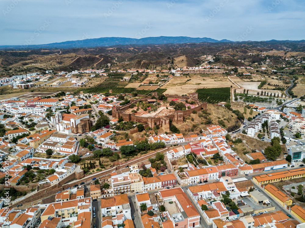 Aerial drone photograph of the Silves Castle.  A medieval fortress built by the Moorish empire/caliphate in the Algarve region of Portugal.  