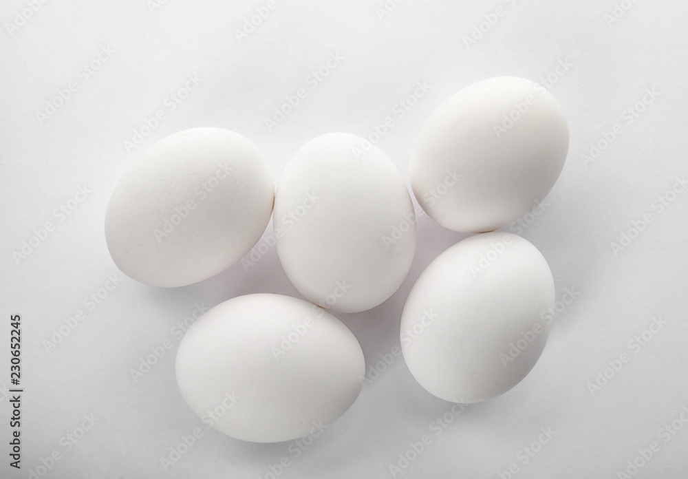 Raw chicken eggs on white background, top view Raw chicken eggs on white background, top view