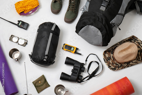 Flat lay composition with camping equipment on white background