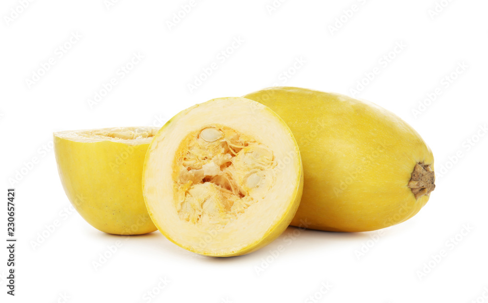 Whole and cut spaghetti squashes on white background