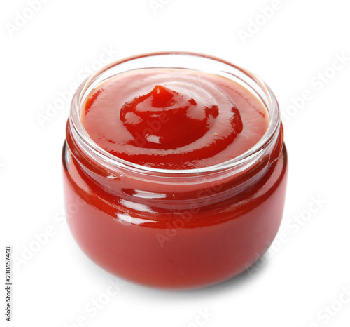 Tasty homemade tomato sauce in glass jar on white background
