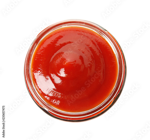 Tasty homemade tomato sauce in glass jar on white background, top view