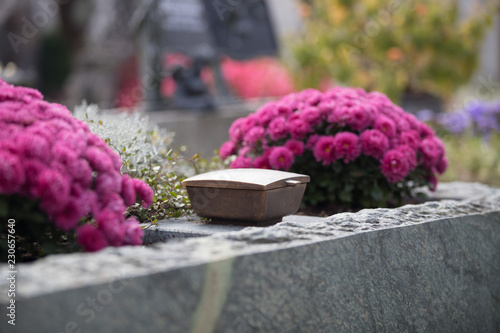 Holy water in iron bowl, cemetery, flowers