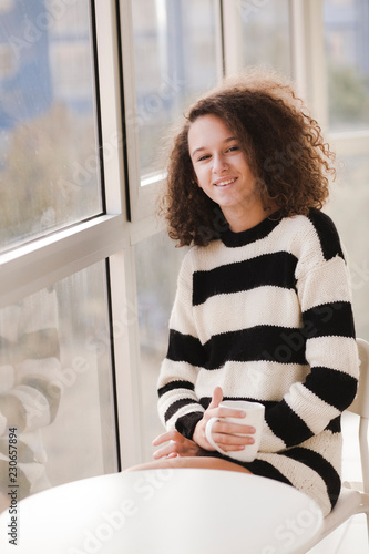 Curly hair teen girl driks ...
