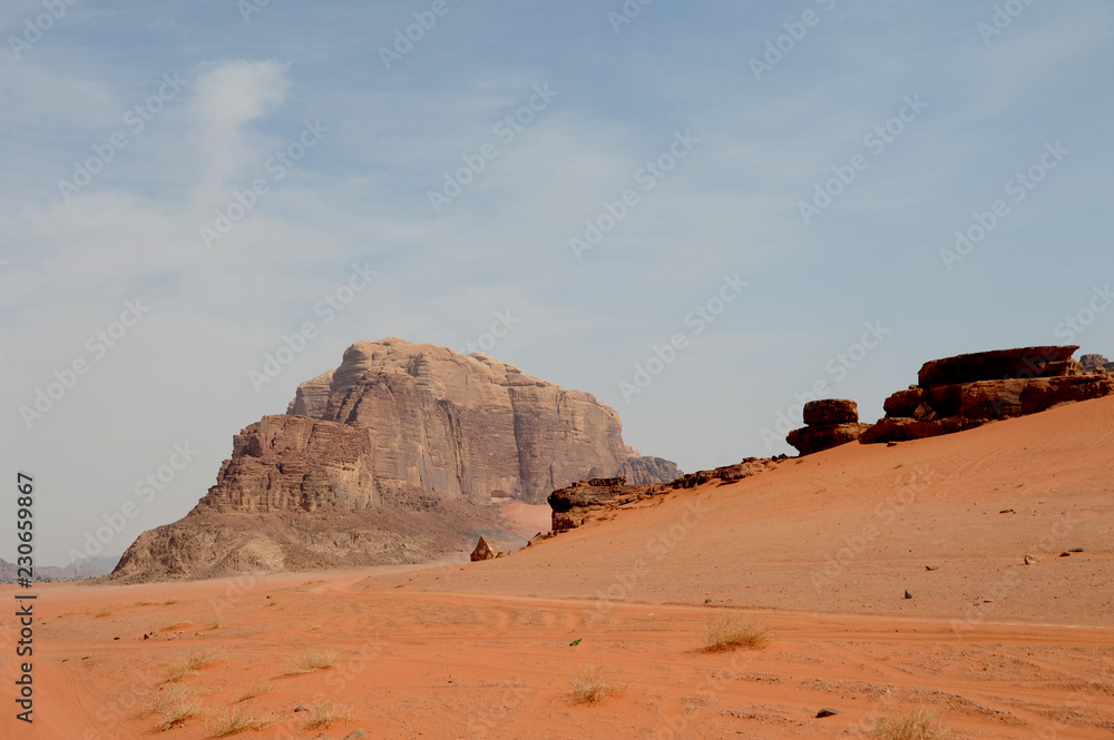 Red mountains of the canyon of Wadi Rum desert in Jordan. Wadi Rum also known as The Valley of the Moon is a valley cut into the sandstone and granite rock in southern Jordan to the east of Aqaba Red mountains of the canyon of Wadi Rum desert in Jordan. Wadi Rum also known as The Valley of the Moon is a valley cut into the sandstone and granite rock in southern Jordan to the east of Aqaba