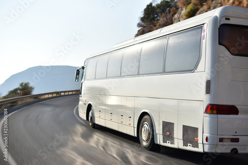 transfer bus for tourists from airport to hotel by mountain road along coast