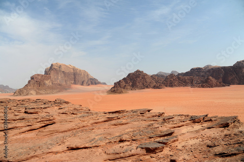 Red mountains of the canyon of Wadi Rum desert in Jordan. Wadi Rum also known as The Valley of the Moon is a valley cut into the sandstone and granite rock in southern Jordan to the east of Aqaba