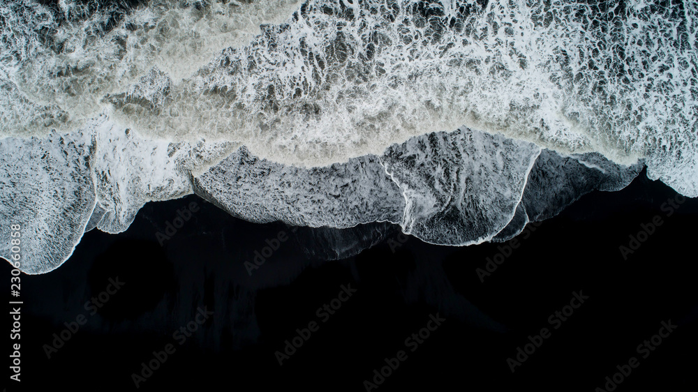 The black sand beach in Iceland. Sea aerial view and top view. Amazing nature, beautiful backgrounds and colors. The black sand beach in Iceland. Sea aerial view and top view. Amazing nature, beautiful backgrounds and colors.