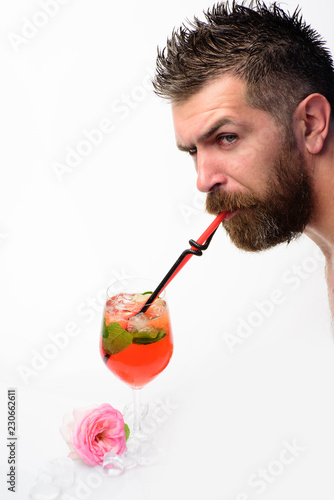 bearded man drinkiing cocktail with straw isolated on white. summer refresh. alcoholic and non alcoholic drinks. bar and restairant. feeling thirst. man drink cocktail from glass. fresh and energetic photo