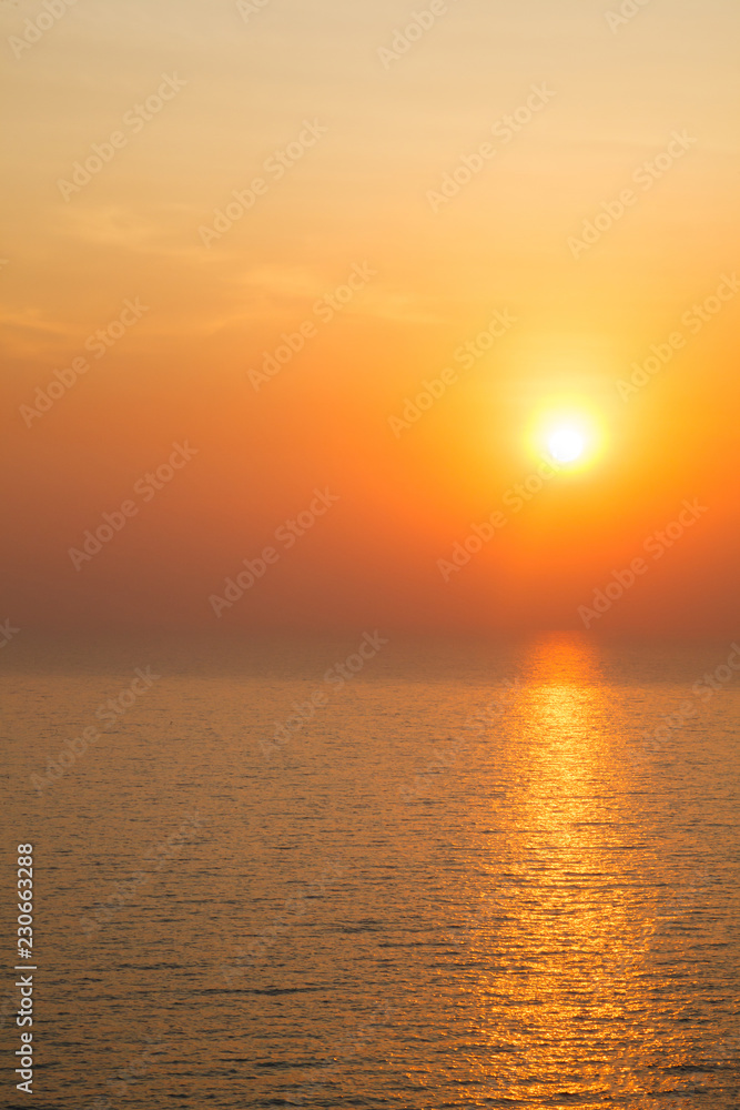 Vertical view of Sunset golden light reflecting on sea wave ripple surface background. Abstract, tranquility, serenity, romance, refresh, relaxation, rest, beauty in nature concept.